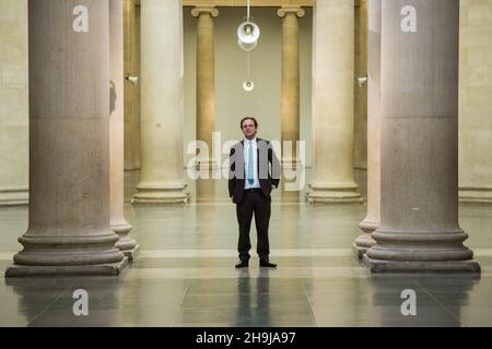 Alex Farquharson, new Director of Tate Britain poses for press photos in the Tate Britain gallery. Alex was previously founding director of Nottingham Contemporary and a well established curator of British art. Quote: 'I am delighted to be joining Tate as Director of Tate Britain. As the home of 500 years of British art, Tate Britain has a unique and fascinating position in the cultural life of the nation. I look forward to working with a highly skilled and experienced team of curators to share these histories with audiences of all kinds.' Stock Photo