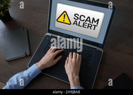Scam alert detecting warning. Notification on device screen. Stock Photo