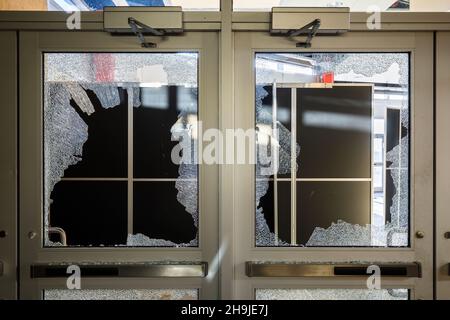 Broken panes of glass in doors. This location has since been demolished. Stock Photo