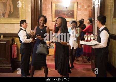 People enjoying a party organised by the Africa Summit on the third floor  of the National Liberal Club at One Whitehall Place, Westminster, London.  Ph Stock Photo - Alamy