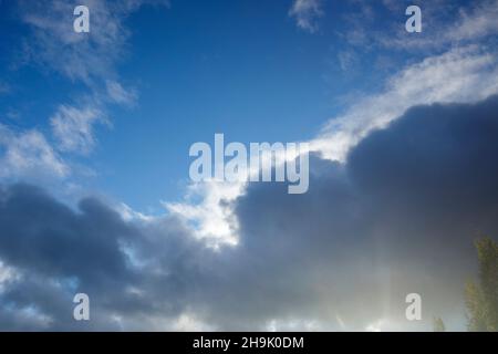 Sun glowing from behind of dark cloud Stock Photo