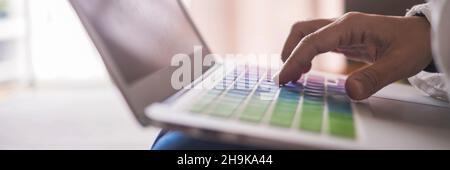Close up of hand writing and typing on laptop keyboard. Concept of online modern work and office activity with people Stock Photo