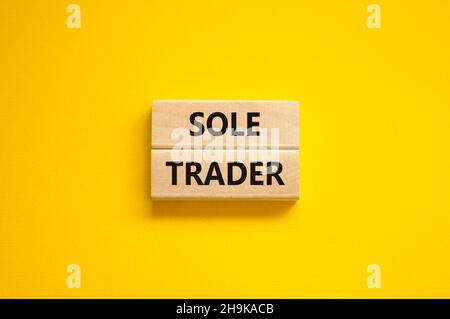 Time to sole trader symbol. Concept words Sole trader on wooden blocks on a beautiful yellow background. Business and sole trader concept. Copy space. Stock Photo