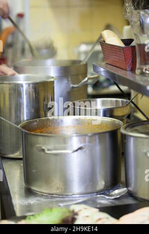 pots, pot, different, many, large kitchen, restaurant, side by side, together, professional, cooking, working, kitchen, spoon, stainless, steel, metal Stock Photo