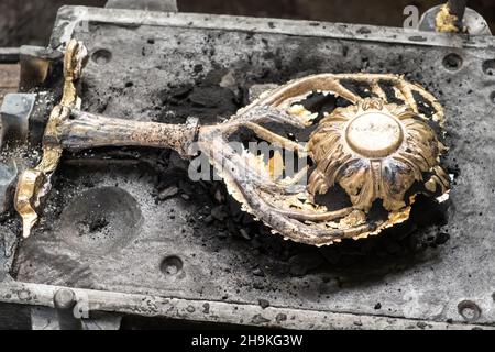 Stylish brass flower with branches in molding form cast in traditional way in ancient production plant workshop extreme close view Stock Photo