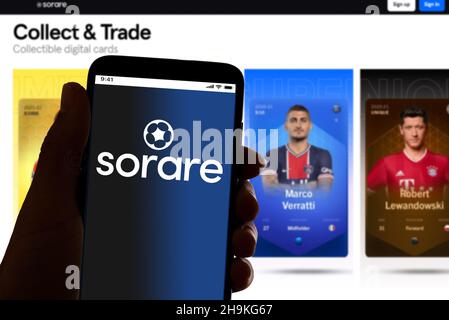 In this photo illustration the logo of the NFT online football marketplace Sorare is seen on the screen of mobile phone and of a laptop in Barcelona, Stock Photo