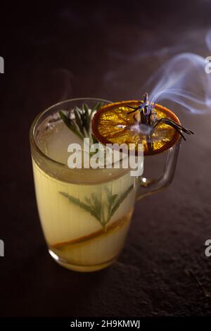 Hot cocktail with orange and rosemary punch. Stock Photo