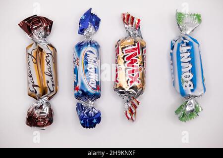 Norwich, Norfolk, UK – December 2021. A fun size Galaxy, Milky Way, Twix and Bounty bar cut out and isolated on a plain white background. These are fo Stock Photo