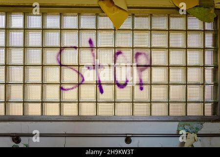 Graffiti in Abandoned Building of Word STOP Stock Photo