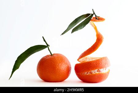 Fresh tangerines with green leaf isolated on white background. Stock Photo