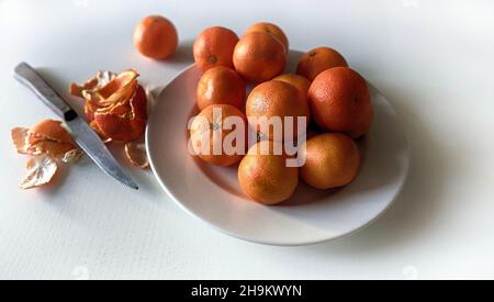 Tangerines on a white plate isolated on white background. Directly above. Stock Photo