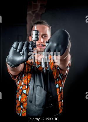 Tattoo artist poses in tattoo parlour./Master of the art of tattooing poses for the camera in tattoo studio. Stock Photo