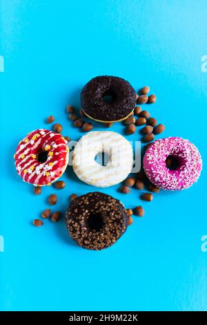 Donut with hazelnuts on a blue background, close up Stock Photo