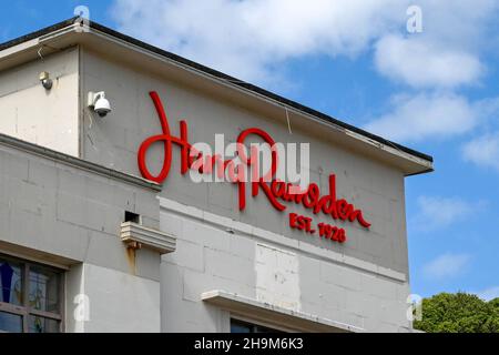 Bournemouth, England - June 2021: Sign on the outside of the branch of the Harry Ramsden chain of fish and chip shops on the seafront Stock Photo