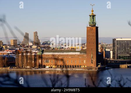 Panorama of Stockholm city on a sunny winter day photographed from the hill. City hall with touristic boat in front. Capital of Sweden Stock Photo