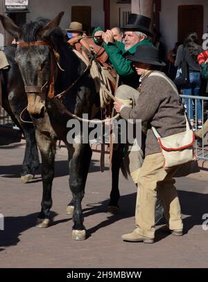 A reenactor portrays trailblazer William Becknell mounting a mule at a reenactment of the 1821 opening of the Santa Fe Trail in Santa Fe, New Mexico. Stock Photo