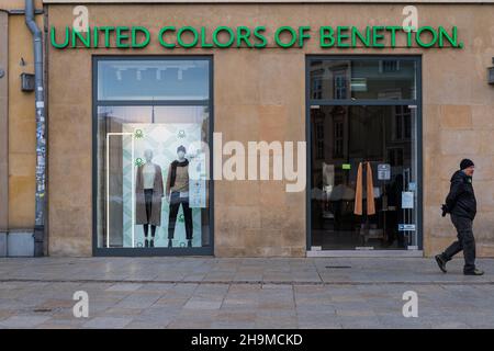 United Colors of Benetton retail clothing store, shop entrance with people, people on street sidewalk, windows and clothes on display Stock Photo