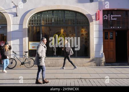 McDonalds in Krakow, Poland, cafe window with people inside, street sidewalk with people, People coming in McDonalds, crowds near McDonalds Stock Photo