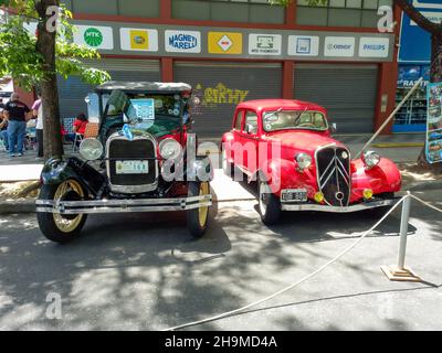 BUENOS AIRES, ARGENTINA - Nov 08, 2021: Vintage green Ford Model A Phaeton 1929 parked beside a red Citroen Traction Avant Legere. Front view. Grille. Stock Photo