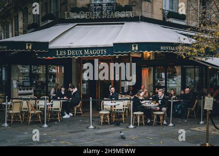 Street scene in Boulevard Saint-Germain des Pres showing people walking around touristic busy area. Paris, France Stock Photo