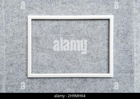Rectangular blank white frame on gray felt. Abstract background. Copy space. Top view.  Stock Photo