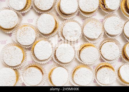 Background of individual small cakes with white sugar on top Stock Photo