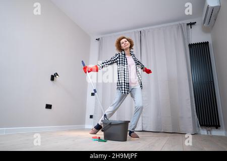 Cleaning Lady smile Fun. Elderly funny housewife fooling around with a ...