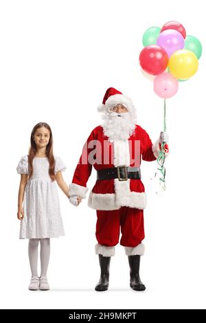 Full length portrait of santa claus with a bunch of balloons holding hands with a girl in a white dress isolated on white background Stock Photo