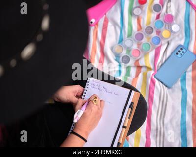 top view of a girl writing notes on characterization make-up designs Stock Photo