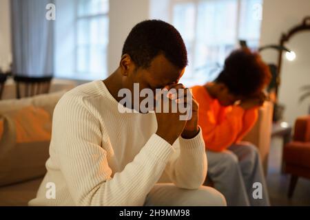 Depressed african man thinks about divorce, upset afro american couple have problems in marriage Stock Photo