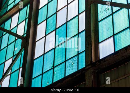 Bullet holes in windows at Ford Island Plane Hangar at Pearl Harbor Stock Photo