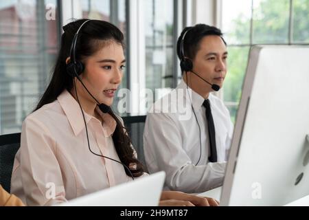 Businesswoman wearing headset working actively in office . Call center,  telemarketing, customer support agent provide service on telephone video  Stock Photo - Alamy