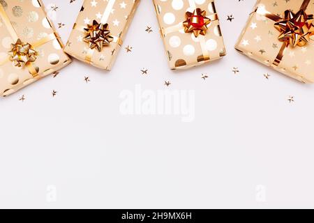 Gift boxes with golden bows on white background. Stock Photo