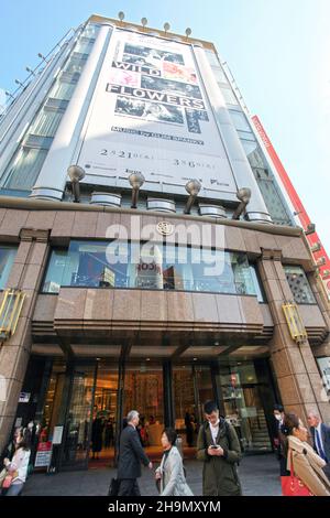 The main entrance and facade of the flagship Mitsukoshi department store in the heart of Ginza in Tokyo, Japan with many people walking around. Stock Photo