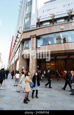 The main entrance and facade of the flagship Mitsukoshi department store in the heart of Ginza in Tokyo, Japan with many people walking around. Stock Photo