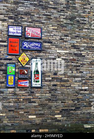 Old product adverts on the side of a building at the Bradford Industrial Museum, West Yorkshire. Stock Photo