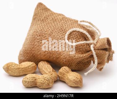 Fresh Peanuts in sack over white background Stock Photo