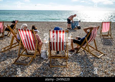 People Enjoying The Summer Sunshine On Seaford Beach, Seaford, East Sussex, UK. Stock Photo