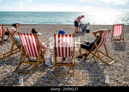 People Enjoying The Summer Sunshine On Seaford Beach, Seaford, East Sussex, UK. Stock Photo
