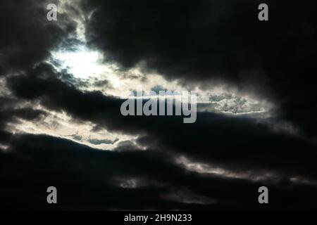 Gloomy sky with black clouds . Light at darkness Stock Photo