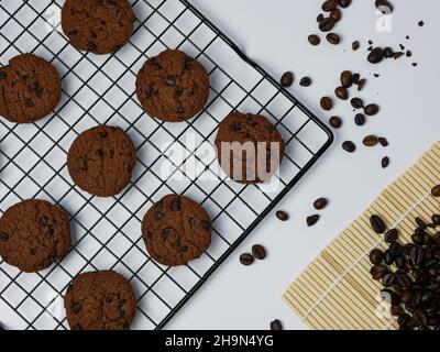 chocolate chip cookies on a grill with coffee beans on a white background. Good morning, flat lay, top view Stock Photo