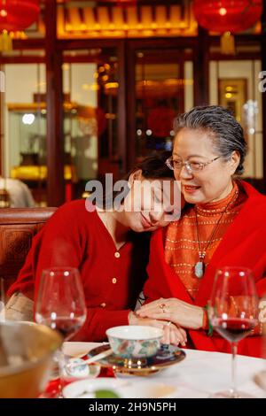 Happy mother and daughter snuggled up together Stock Photo