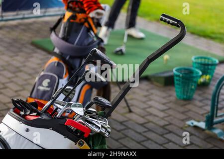 Minsk. Belarus - 16.10.2021 - Silver golf clubs in the bag on the field Stock Photo