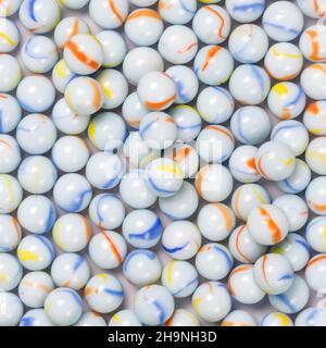 blueish white crystal spheres, background texture of colorful marbles, wallpaper or backdrop for designing closeup taken from above Stock Photo
