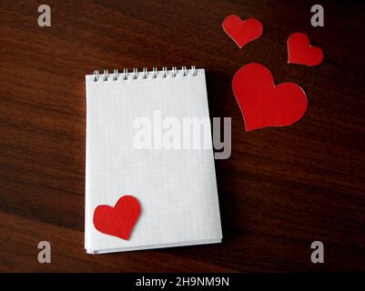 Blank Writing Pad with Heart Shapes on The Table Stock Photo