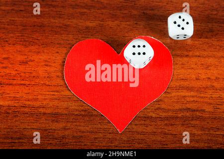 Red Heart Shape with Dices on the Wooden Background Stock Photo