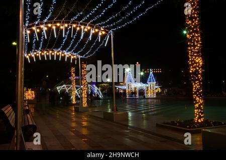 Yalta Crimea December 28, 2019. New Year decorations of the city. Bright festive lights sparkle in the night city. Blurry background without people. T Stock Photo