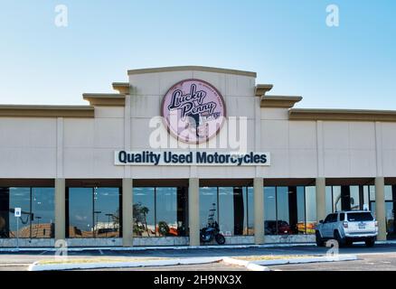 Houston, Texas USA 11-12-2021: Lucky Penny Cycles storefront and parking lot in Houston TX. Quality Used Motorcycles local business. Stock Photo