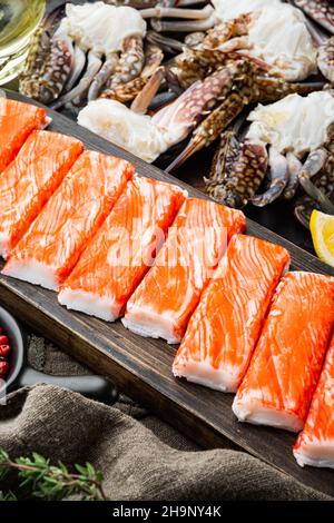 Crab sticks seafood semi finished fish mince with blue swimming crab set, on dark wooden background Stock Photo
