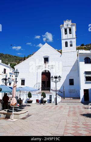 View of San Antonio Church with a pavement cafe in the foreground, Frigiliana, Spain. Stock Photo